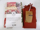 a red bag with a red cover next to a red pillow
