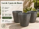 three planters sitting on top of a table next to a sign
