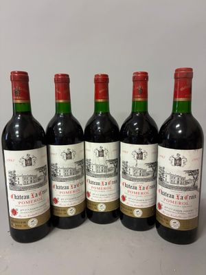 six bottles of red wine are lined up on a table