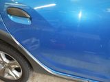 a close up of a blue car with a door handle