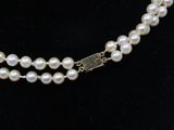 two strand pearl necklace with a silver clasp and clasp
