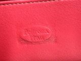 the inside of a red leather purse with the name of the company on it