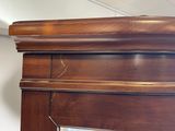 a close up of a mirror on a wooden cabinet