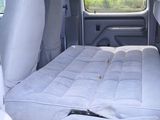 a bed in the back of a van with a mattress on it