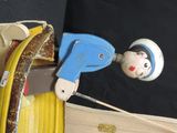 a toy figure that is holding a hose and a spool