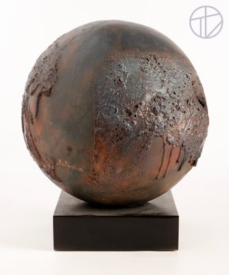 a metal sculpture of a ball on a wooden base