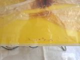 a plastic bag on a table with a banana on it