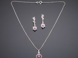 a necklace and earring set with pink sapphire and diamonds