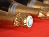 several bottles of champagne are lined up on a red surface