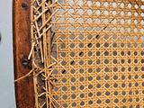 a wicker chair that has a hole in the back