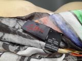 a close up of a pile of clothing with a label on it