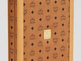 an image of a brown suitcase with a skull and crossbone pattern