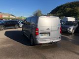 a silver van that is parked in a parking lot
