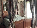 a bed with a canopy in a room with a tiled floor