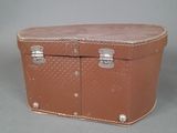a brown suitcase sitting on top of a table
