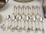 a lot of silver spoons and forks on a table