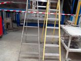 two ladders that are sitting in a garage