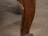 an old wooden chair sitting on top of a hard wood floor