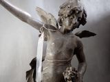 a statue of an angel with a ribbon around his neck