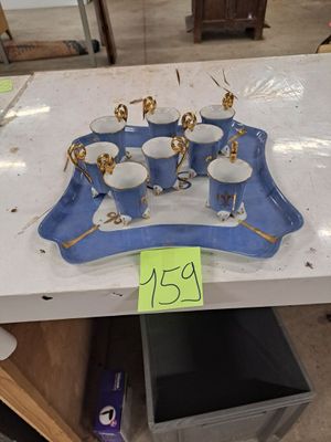 a tray with cups and saucers on it with a price tag