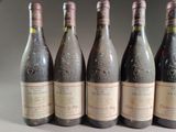 six bottles of wine are lined up on a table