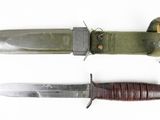 two different types of knives on a white surface