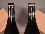 two bottles of wine that are sitting on a table