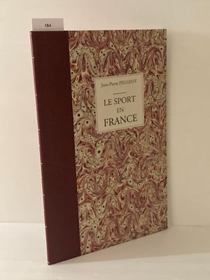 Le livre est posé sur une surface blanche, près d'un mur blanc.