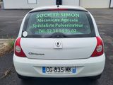 the back of a small white car parked in a parking lot