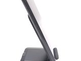 a cell phone on a stand on a white surface
