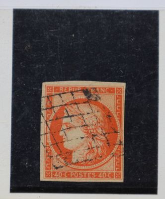 un timbre orange et noir sur lequel figure l'image d'une femme