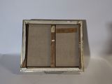 a small box with a cross inside of it on a table