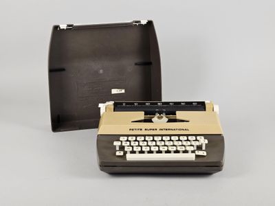 une vieille machine à écrire posée à côté d'une boîte sur laquelle est dessinée une étoile