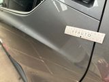 a sticker on the door of a silver car