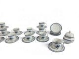 a group of blue and white porcelain dishes and cups and saucers