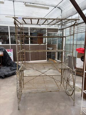 a metal bed that is in the middle of a room