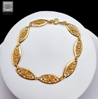 a picture of a gold plated bracelet on a mannequin