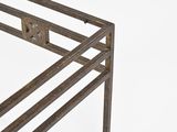 a metal table with a metal frame on top of it