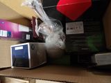 a microwave sitting in a box on a shelf