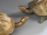 pair of antique brass turtle figurines on a white background