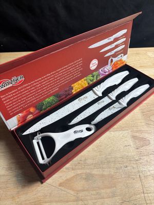 a box with three knives and a knife sharper in it