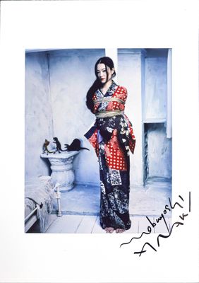 signed photograph of a woman in a red and black sari