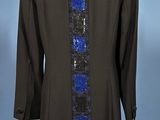 an image of a black jacket with blue sequins on a mannequin stand