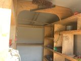 a room that has a lot of wooden shelves in it