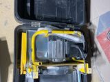 a tool box that has a tool in it on the floor
