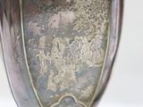 a silver vase sitting on top of a wooden stand