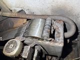 a dirty car engine with a hose attached to it