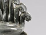a silver vase that has a bunch of flowers in it