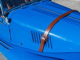 a close up of a blue car with a brown leather strap