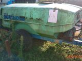a tractor with a trailer attached to it in the grass